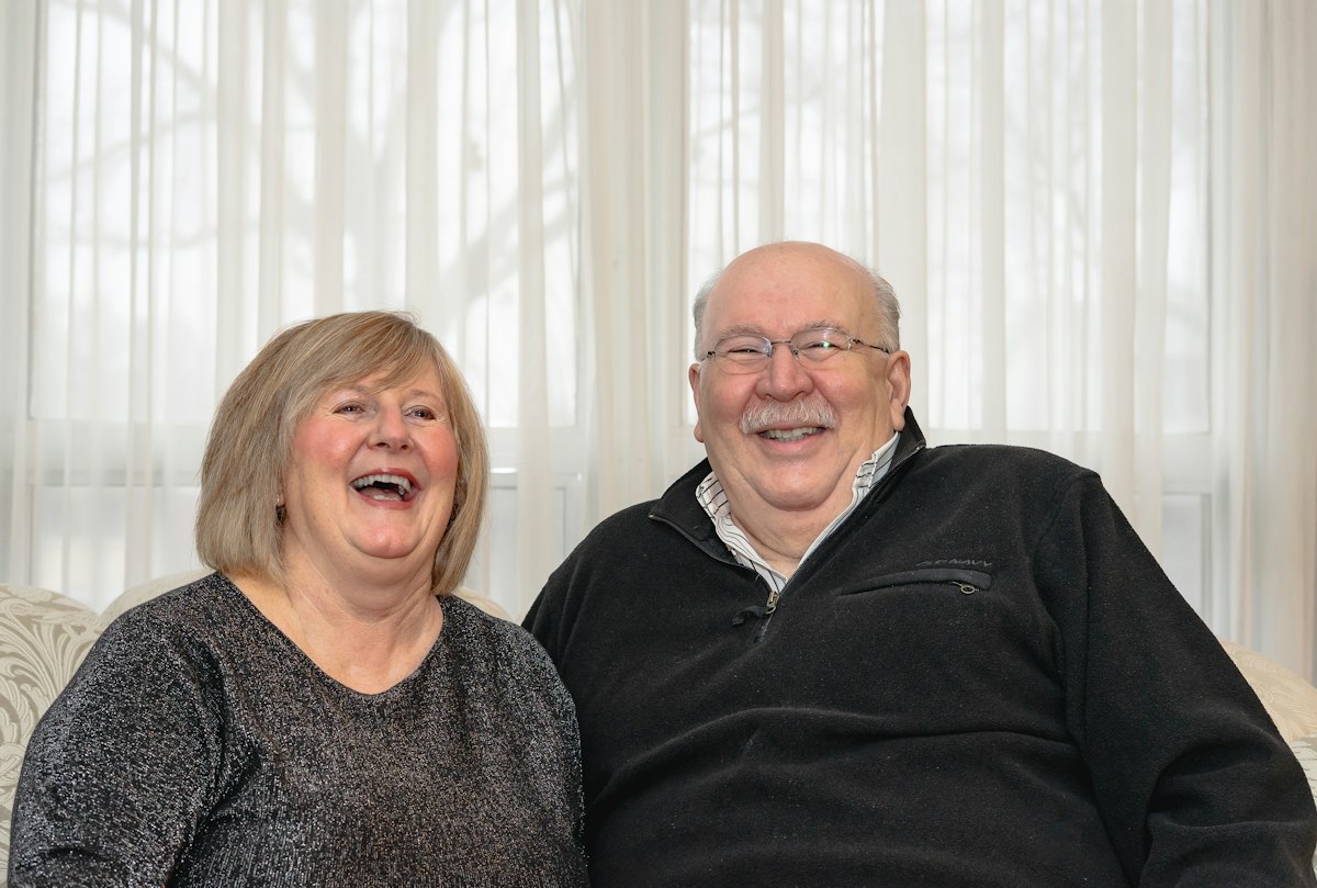 An older couple laughing together