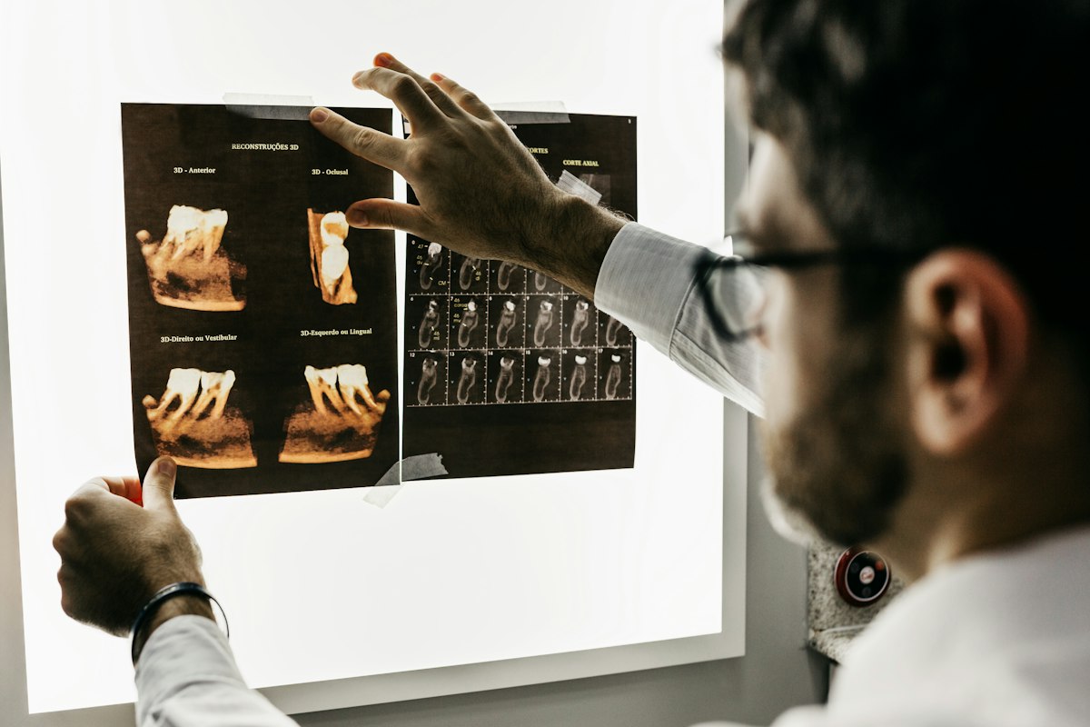 A dentist studying X-ray images on a light box