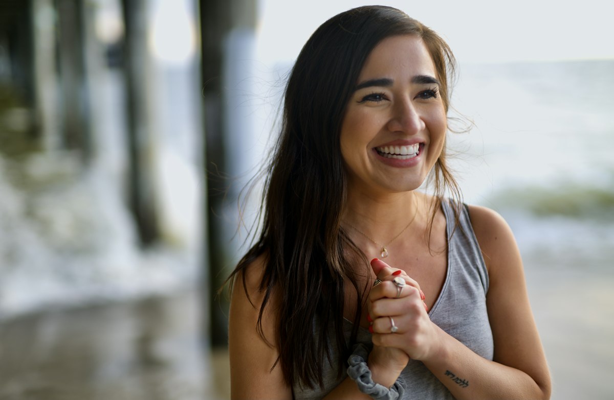 A woman smiling outdoors