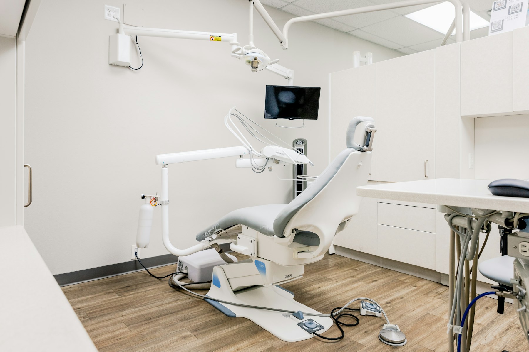 A bright dental room with the chair in the middle