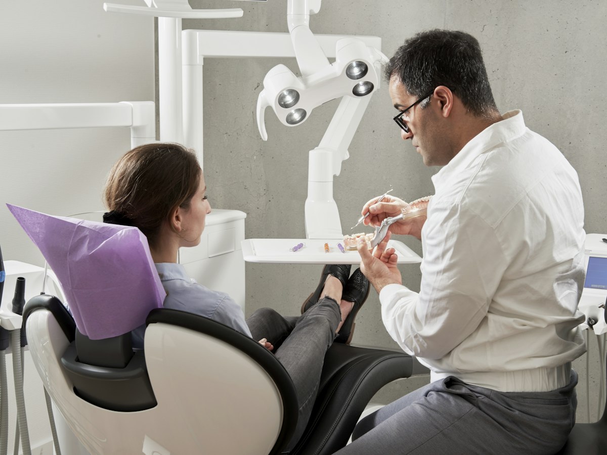 A dentist examining a patient in the chair
