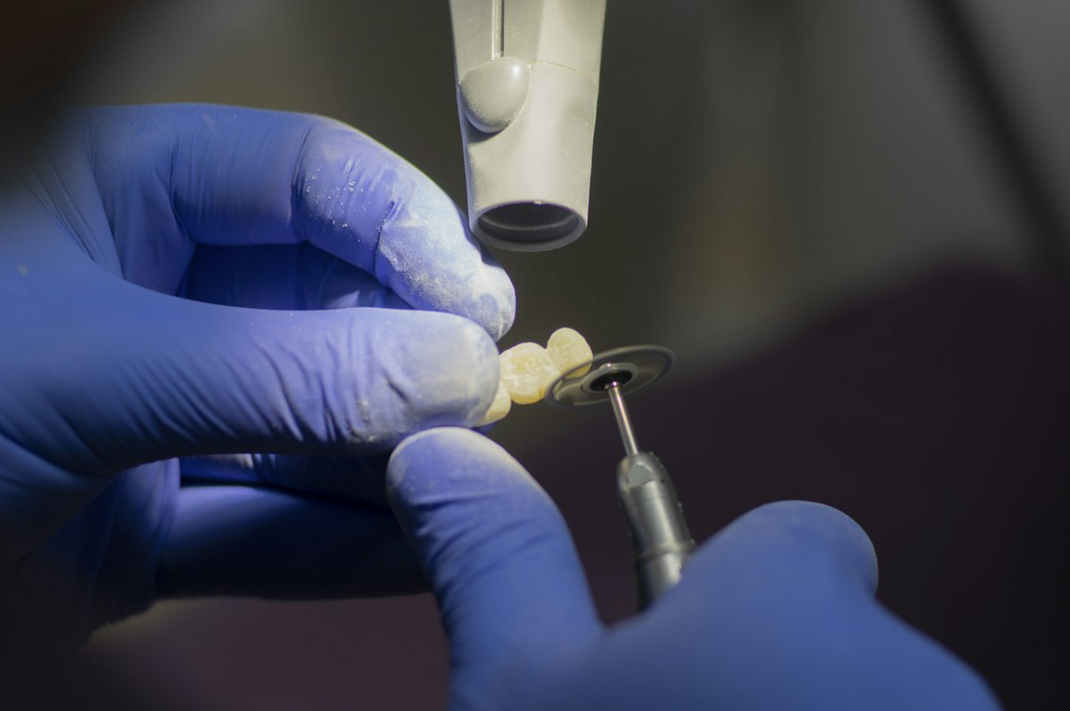 A crown being shaped by hand